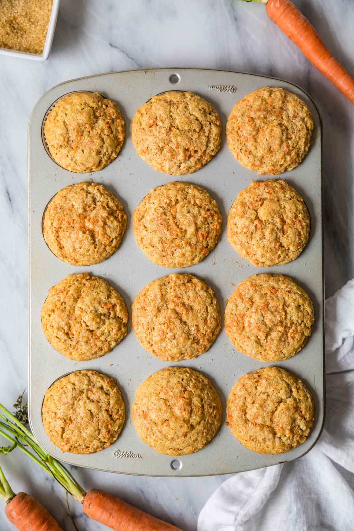 Overhead view of muffins in a muffin pan after baking.