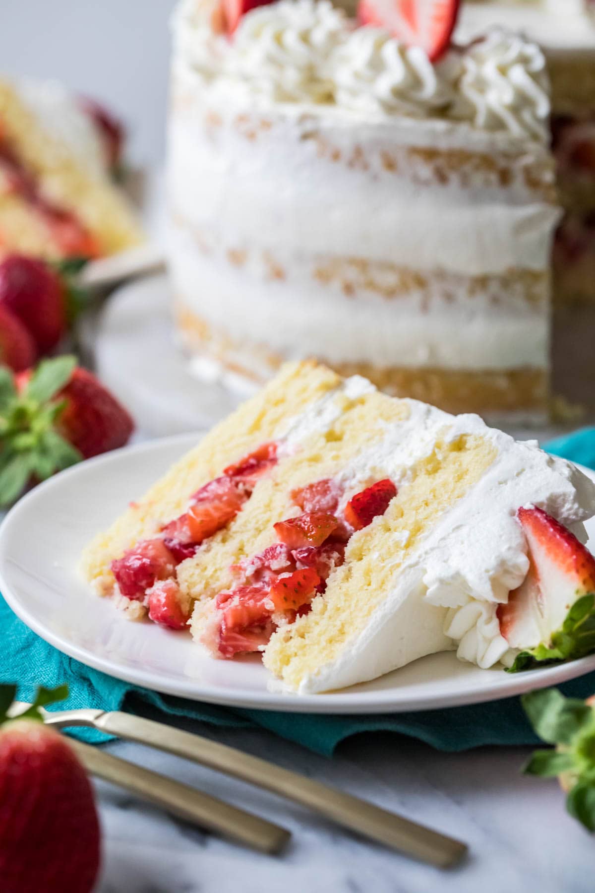Slice of strawberry shortcake cake on a plate.