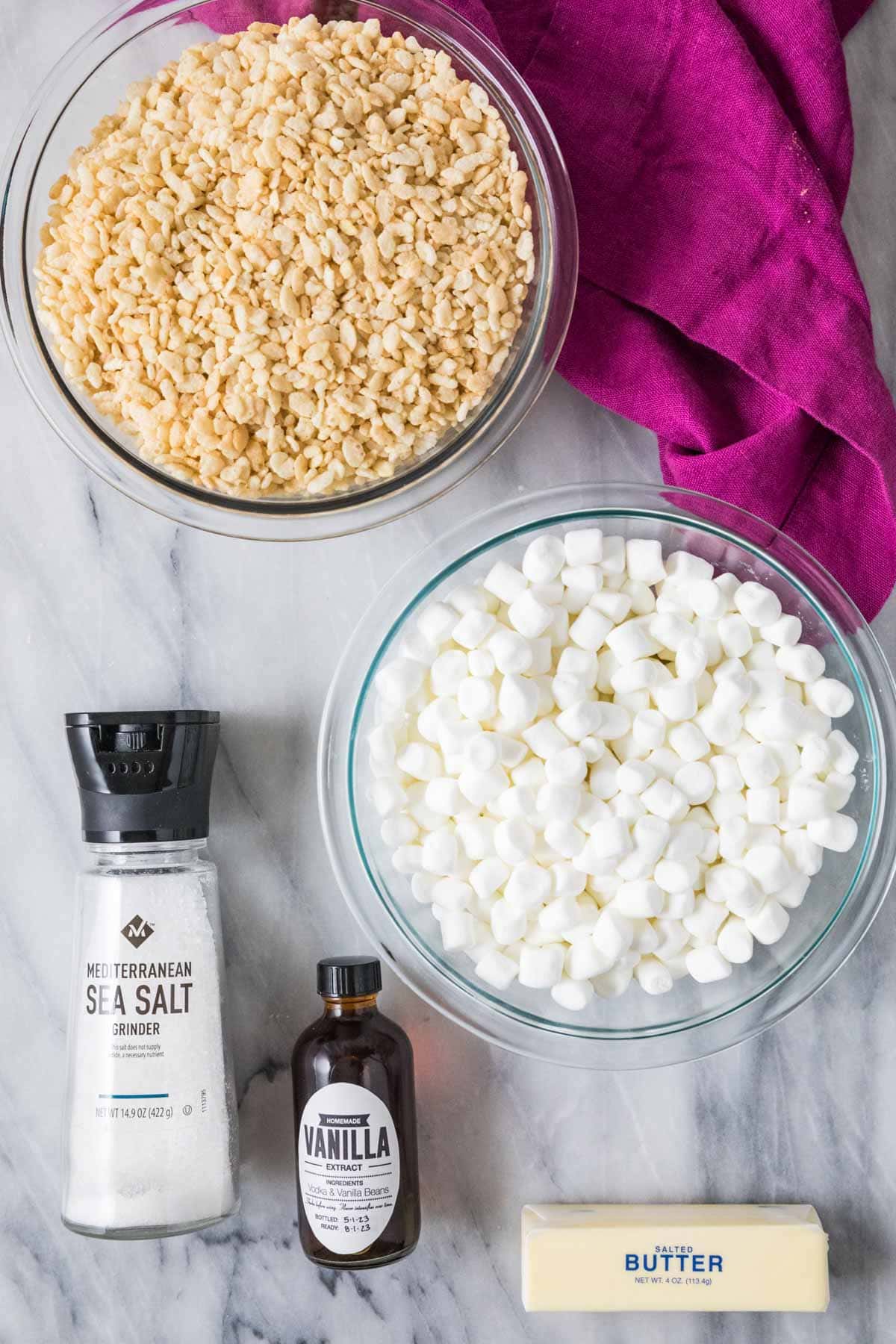 Overhead view of ingredients including rice krispies, marshmallows, butter, and more.