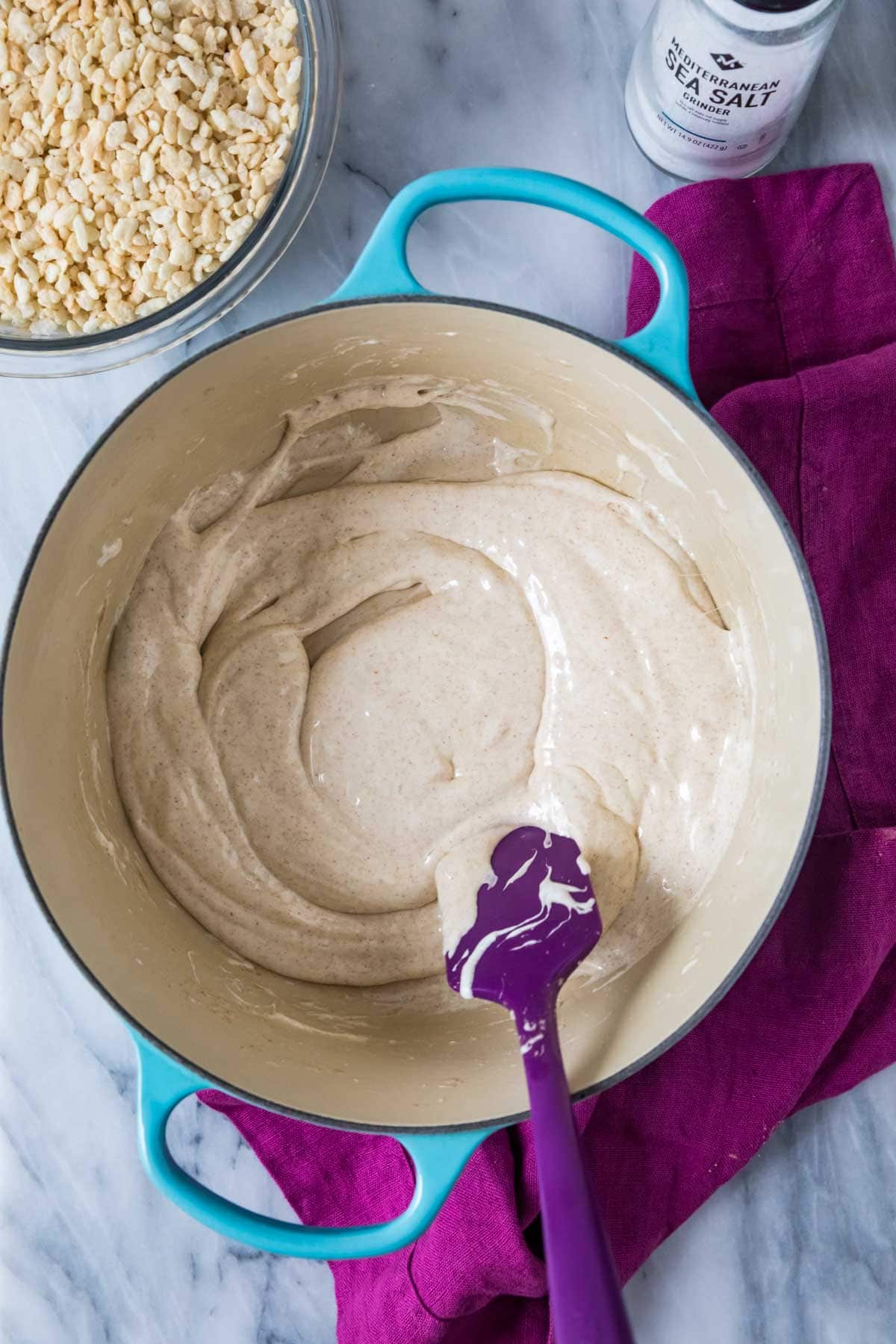 Overhead view of a melted marshmallow and brown butter mixture in a saucepan.