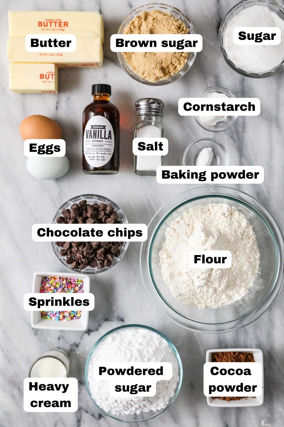 Overhead view of labelled ingredients including brown sugar, cocoa powder, chocolate chips, and more.