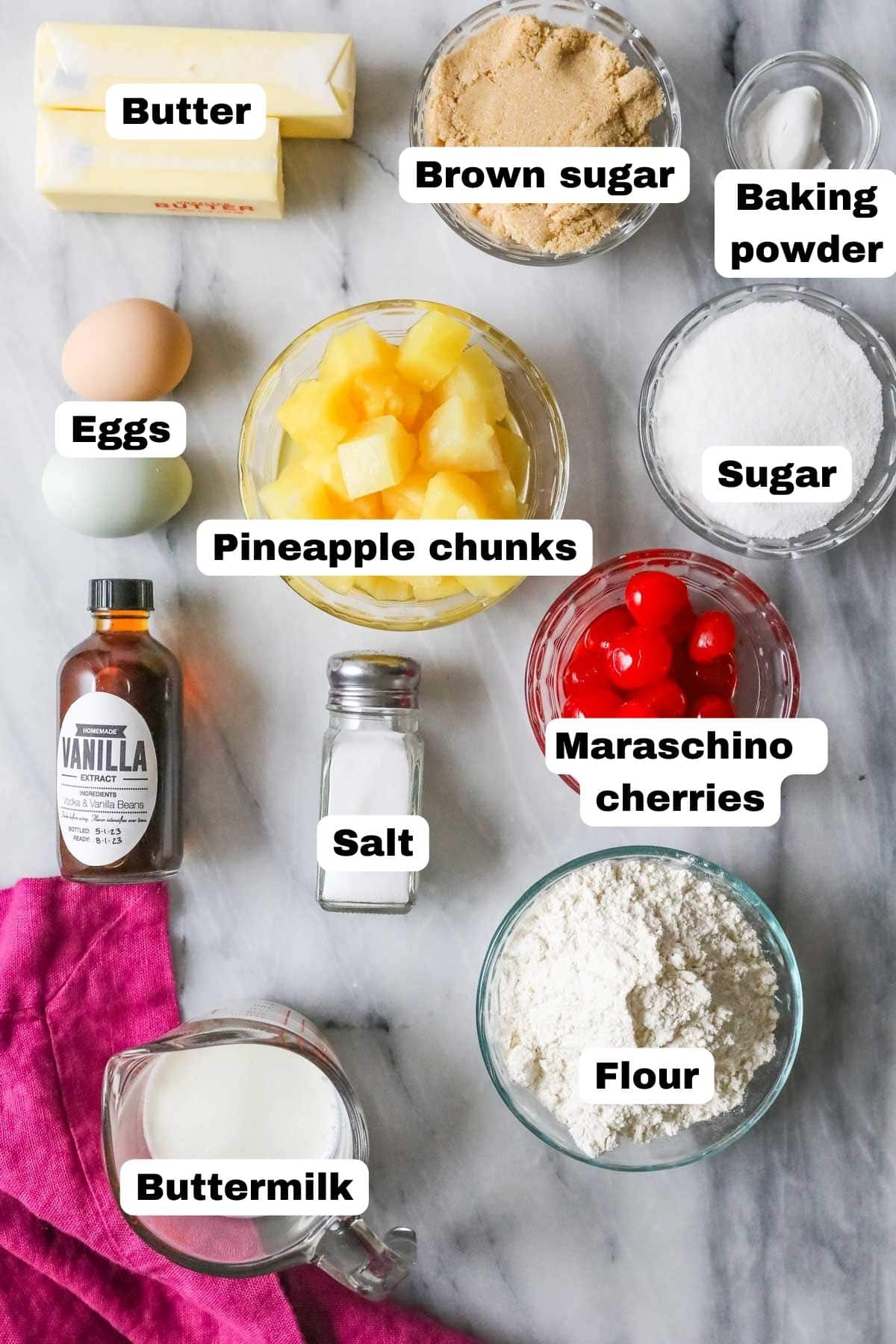 Overhead view of labelled ingredients including pineapple chunks, cherries, brown sugar, and more.