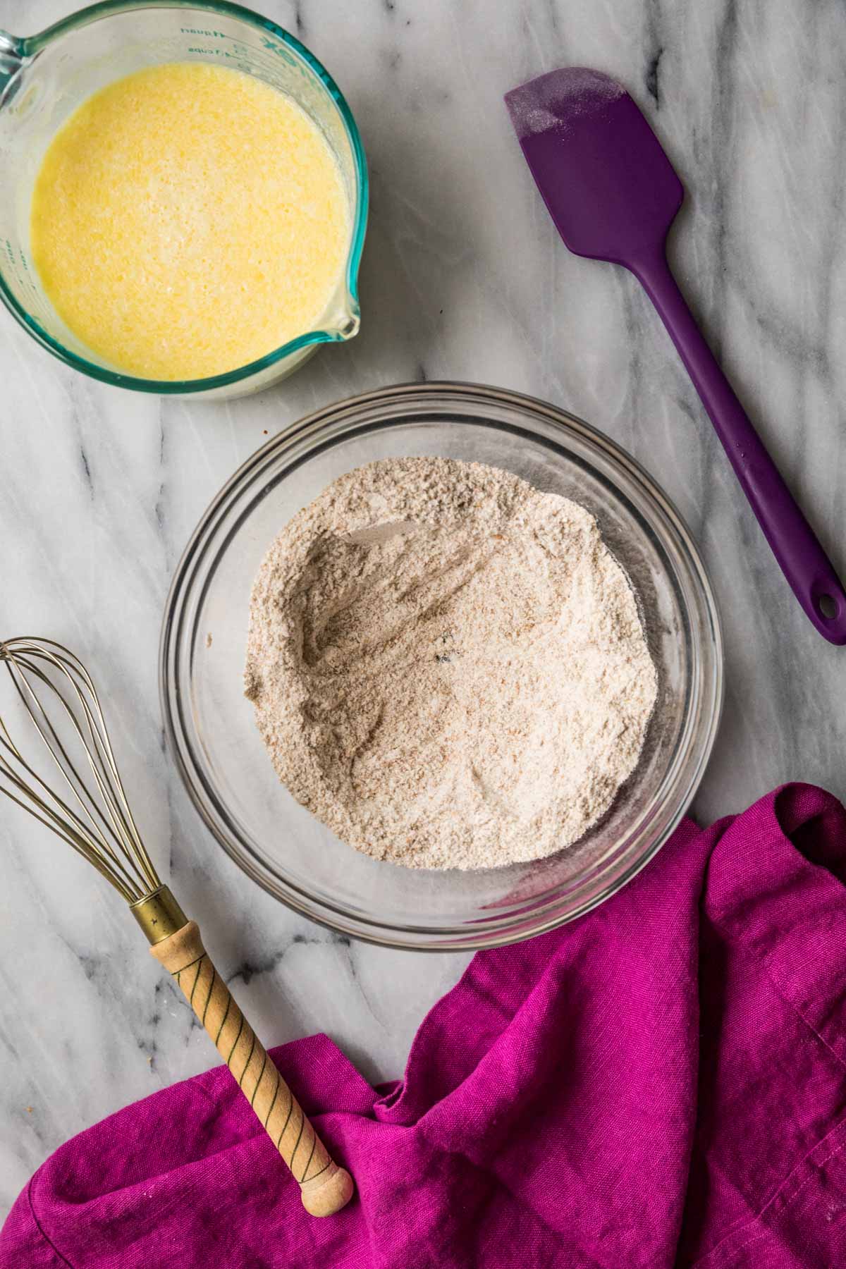 Overhead view of dry ingredients whisked together in a bowl.