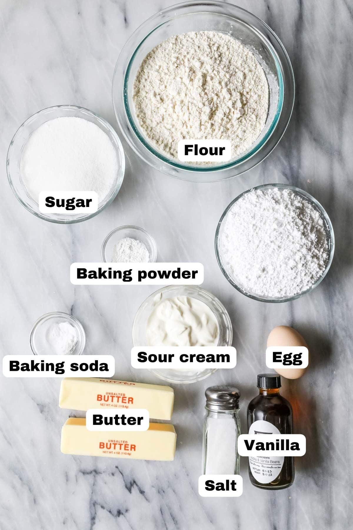 Overhead view of labelled ingredients including sour cream, butter, egg, and more.