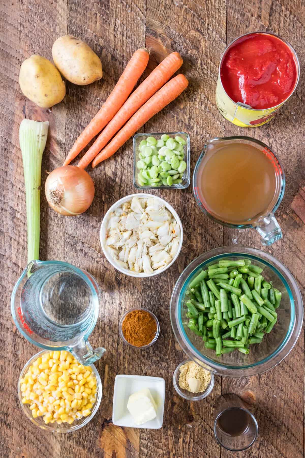 Overhead view of ingredients including crab meat, old bay, beef broth, and more.