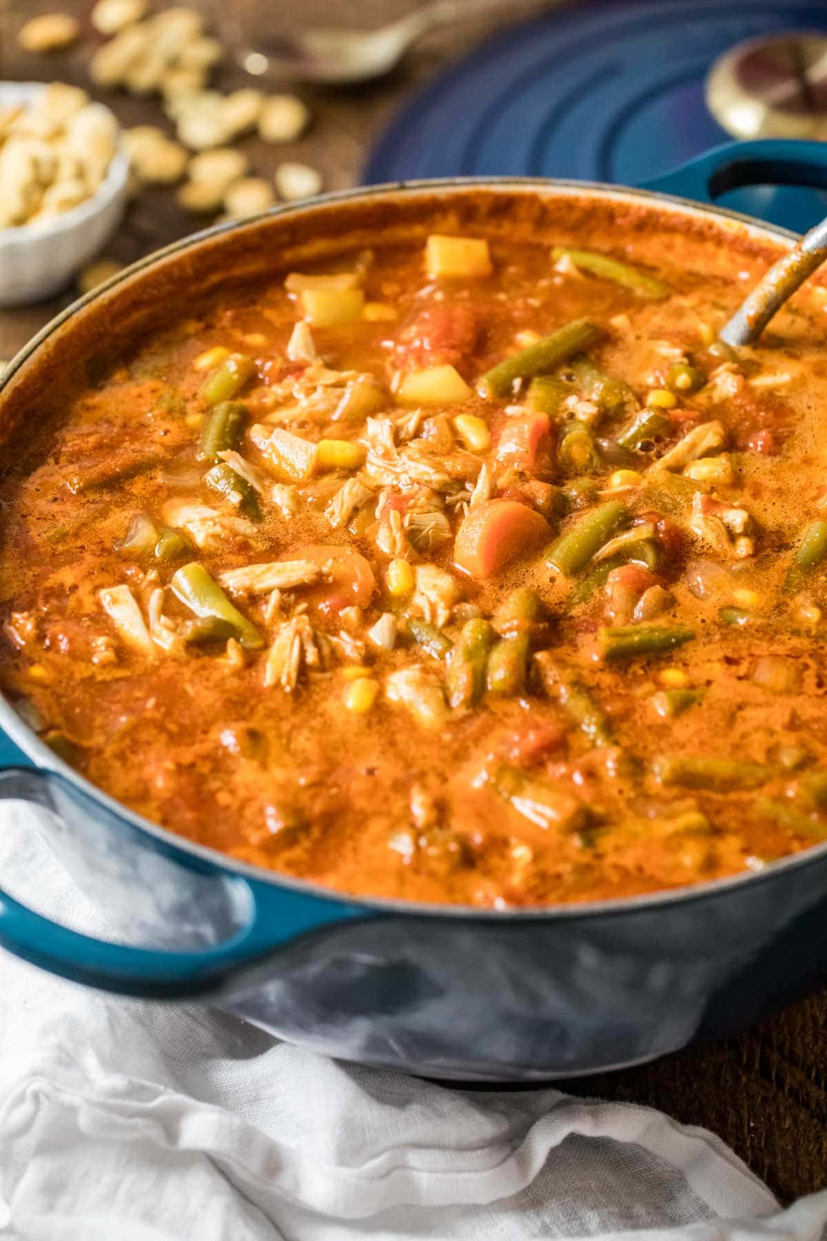 Pot of maryland crab soup made with a tomato base, lump crab meat, old bay, and more.