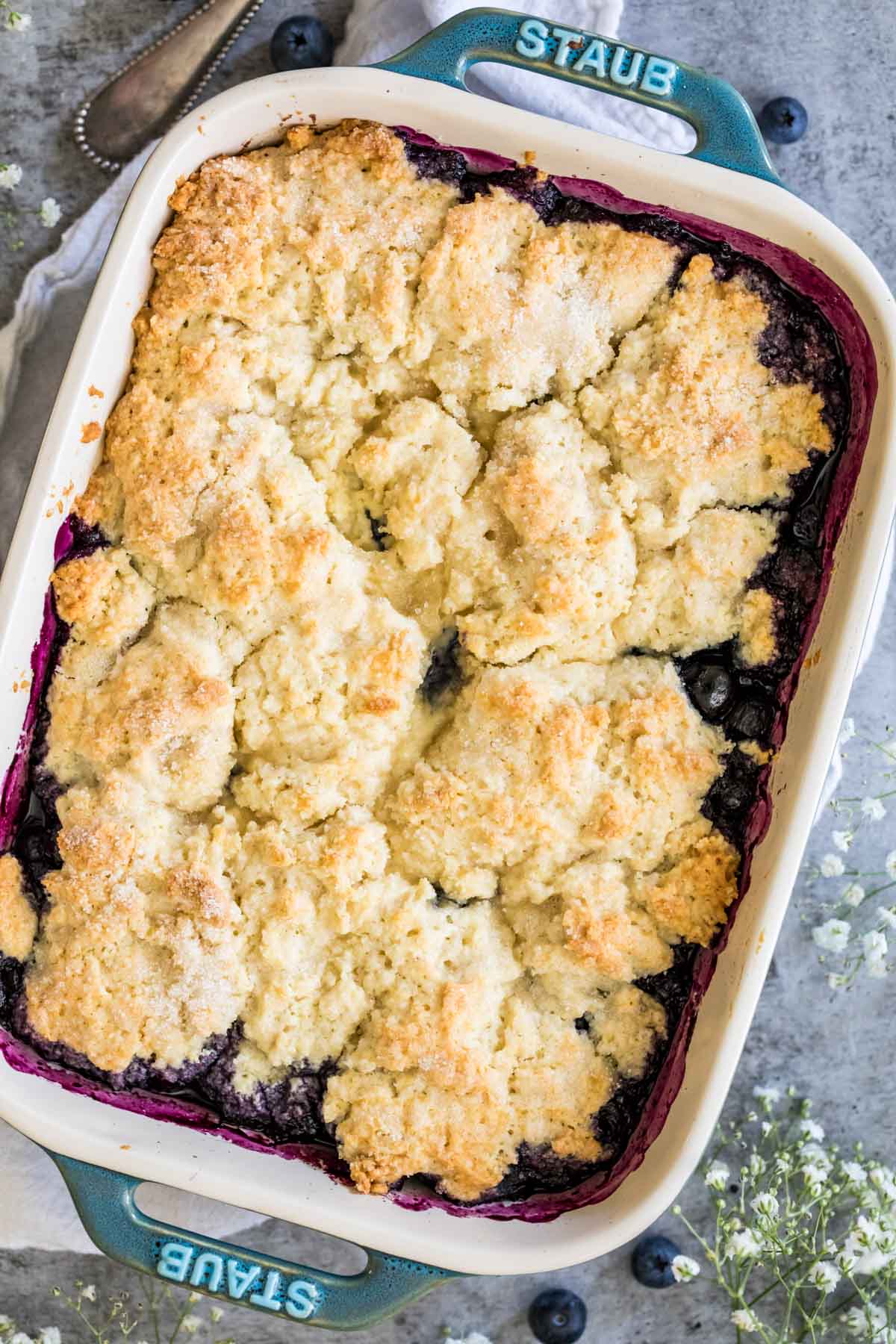Overhead view of a baking pan of blueberry cobbler.