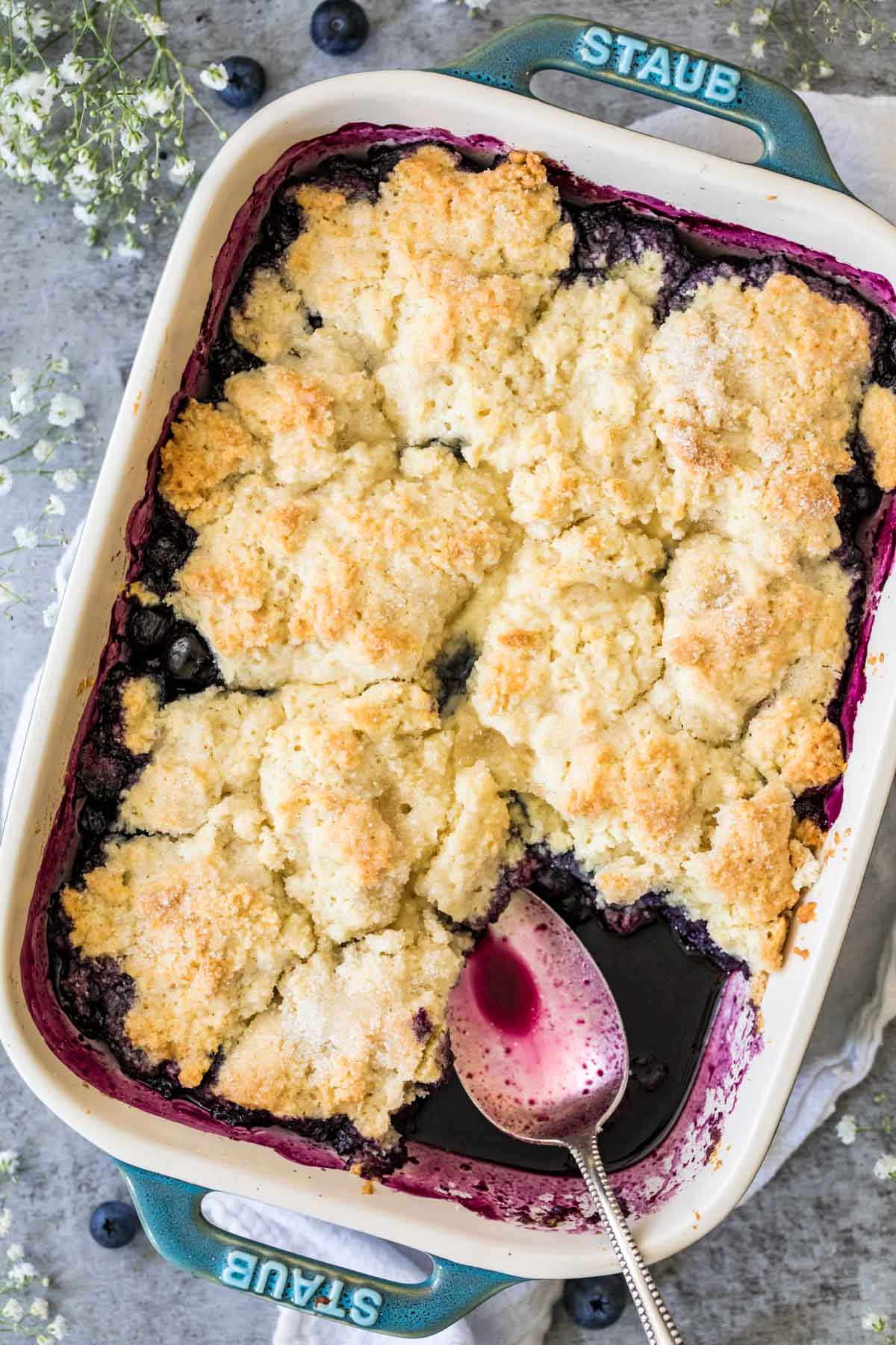 Overhead view of a baking pan of blueberry cobbler.
