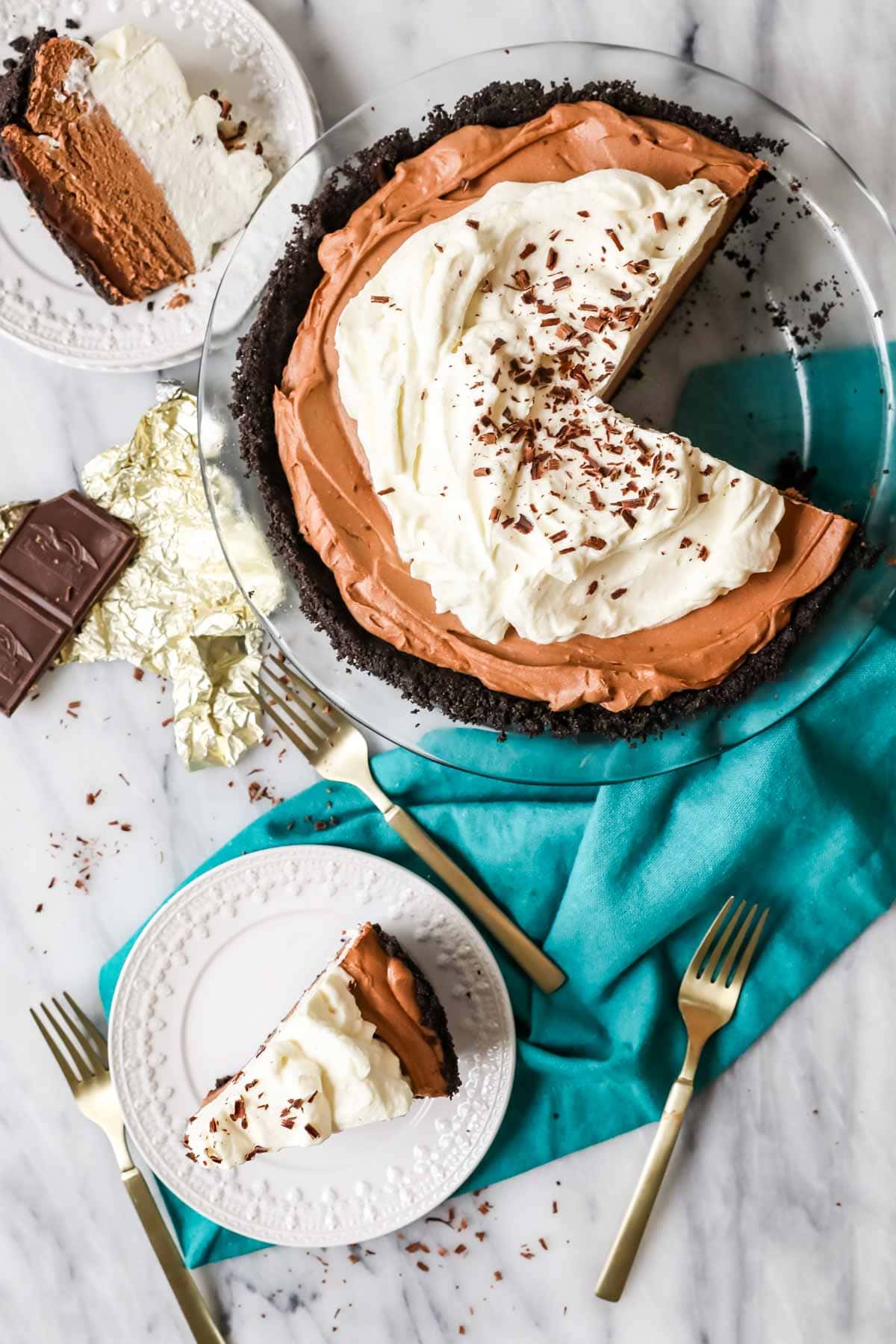 Overhead view of a chocolate based no-bake pie with two slices missing.