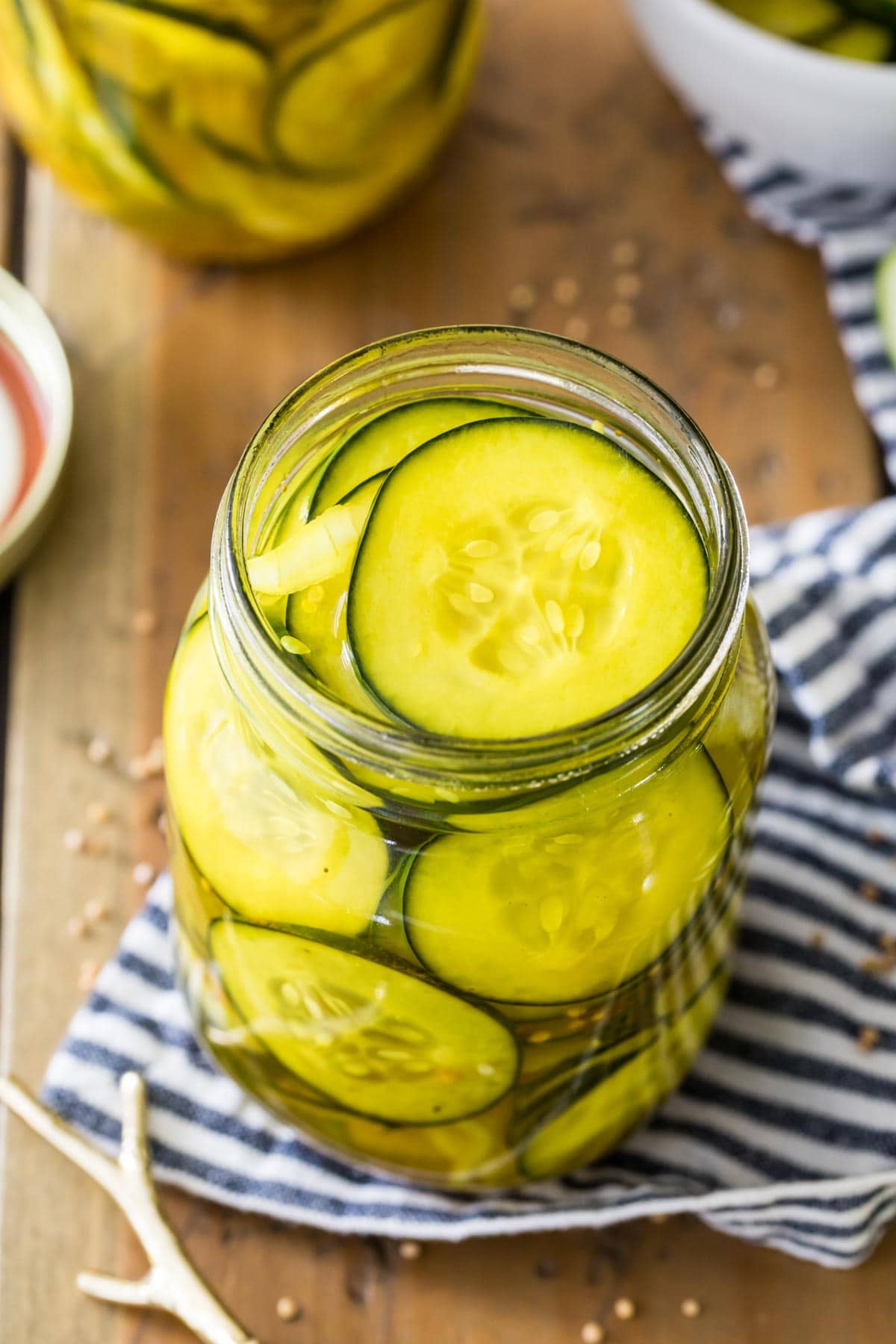 Jar of homemade pickles on a striped towel.