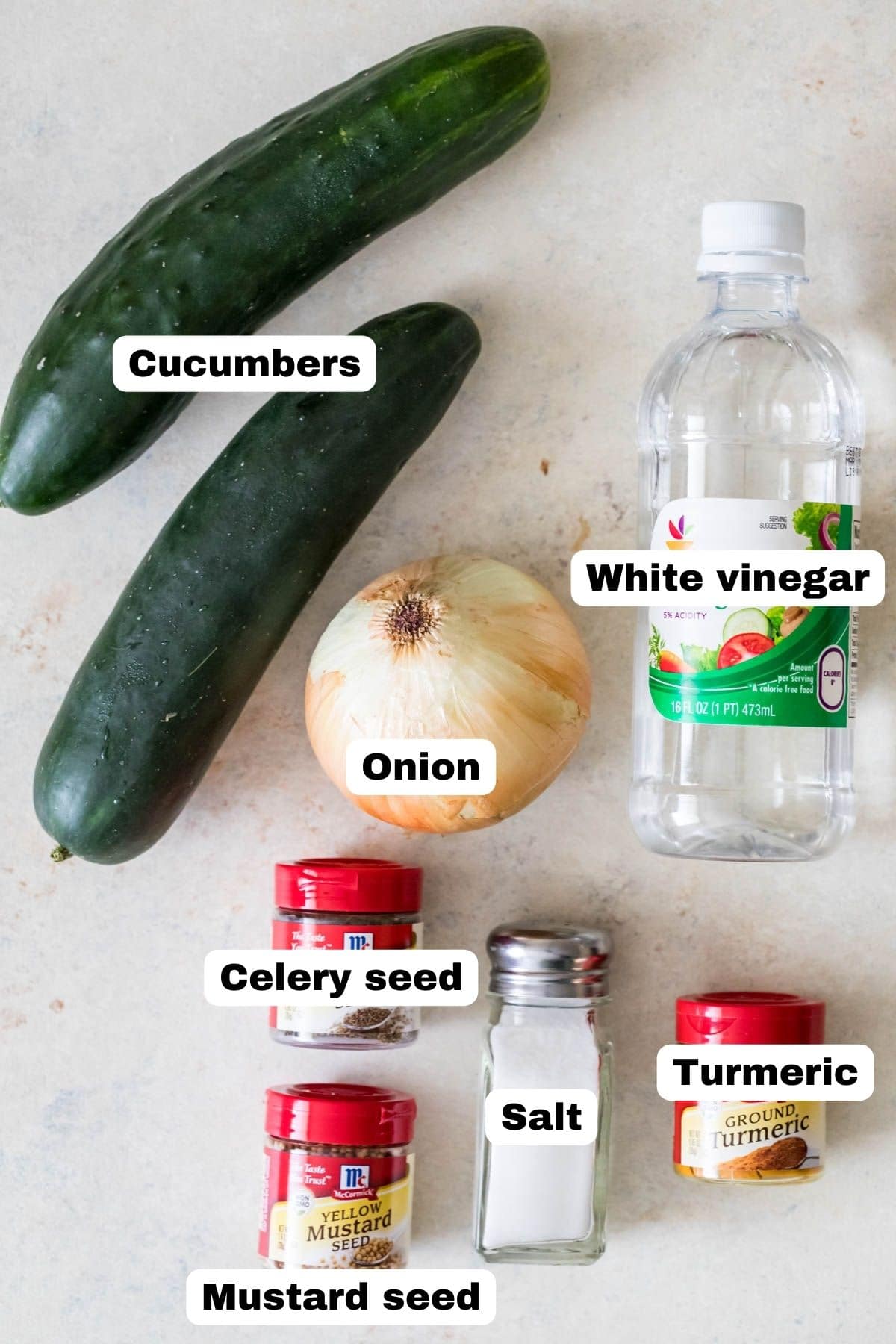 Overhead view of labeled ingredients including cucumbers, onion, vinegar, and more.