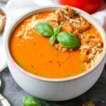 Overhead view of a bowl of tomato basil soup made with fresh tomatoes and basil.
