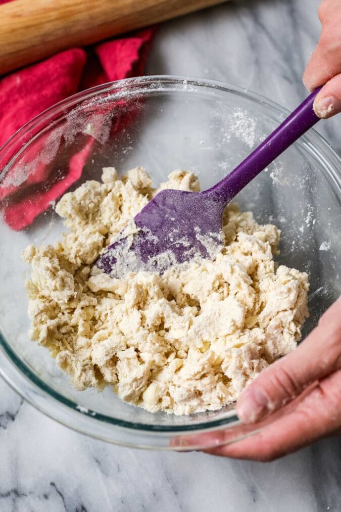 Bowl of shaggy pie dough made with sourdough discard.