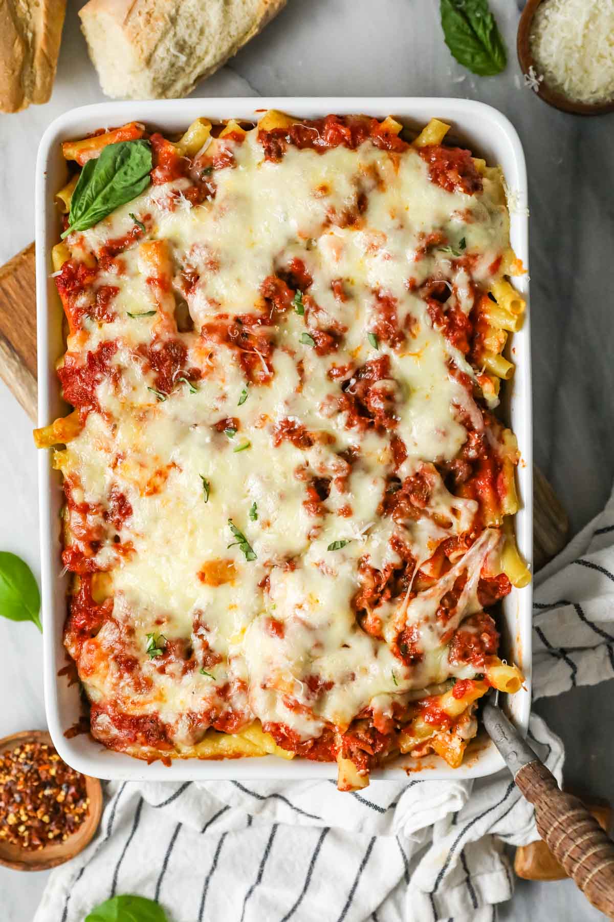 Overhead view of a baked pasta dish topped with shredded mozzarella.
