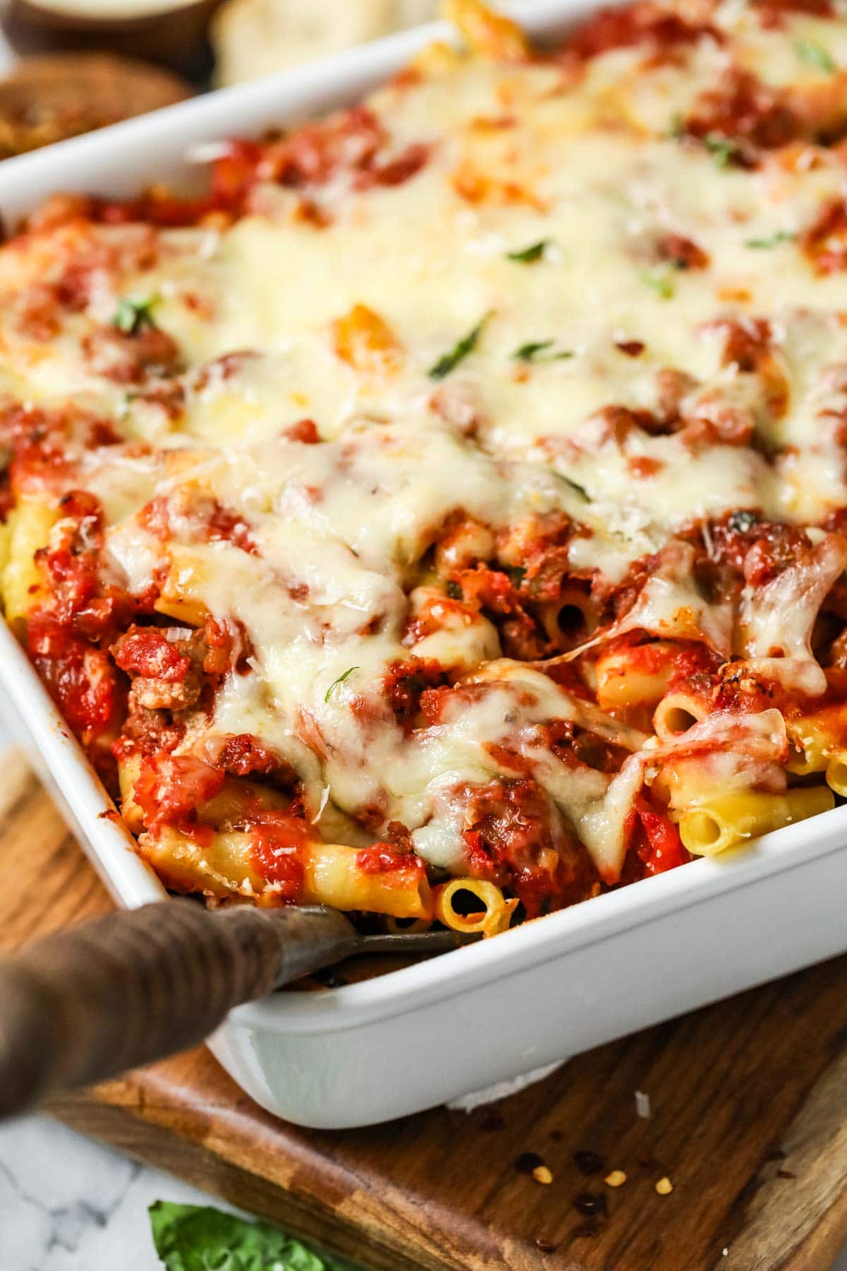 Close-up view of baked ziti in a baking dish.