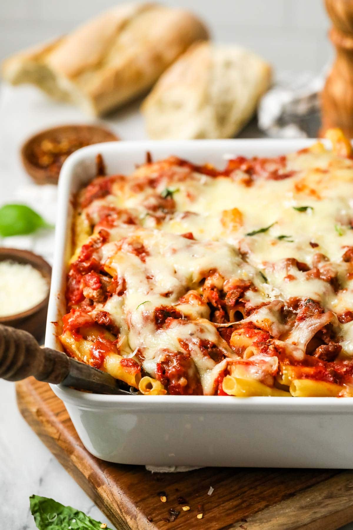 Close-up view of baked ziti in a baking dish.