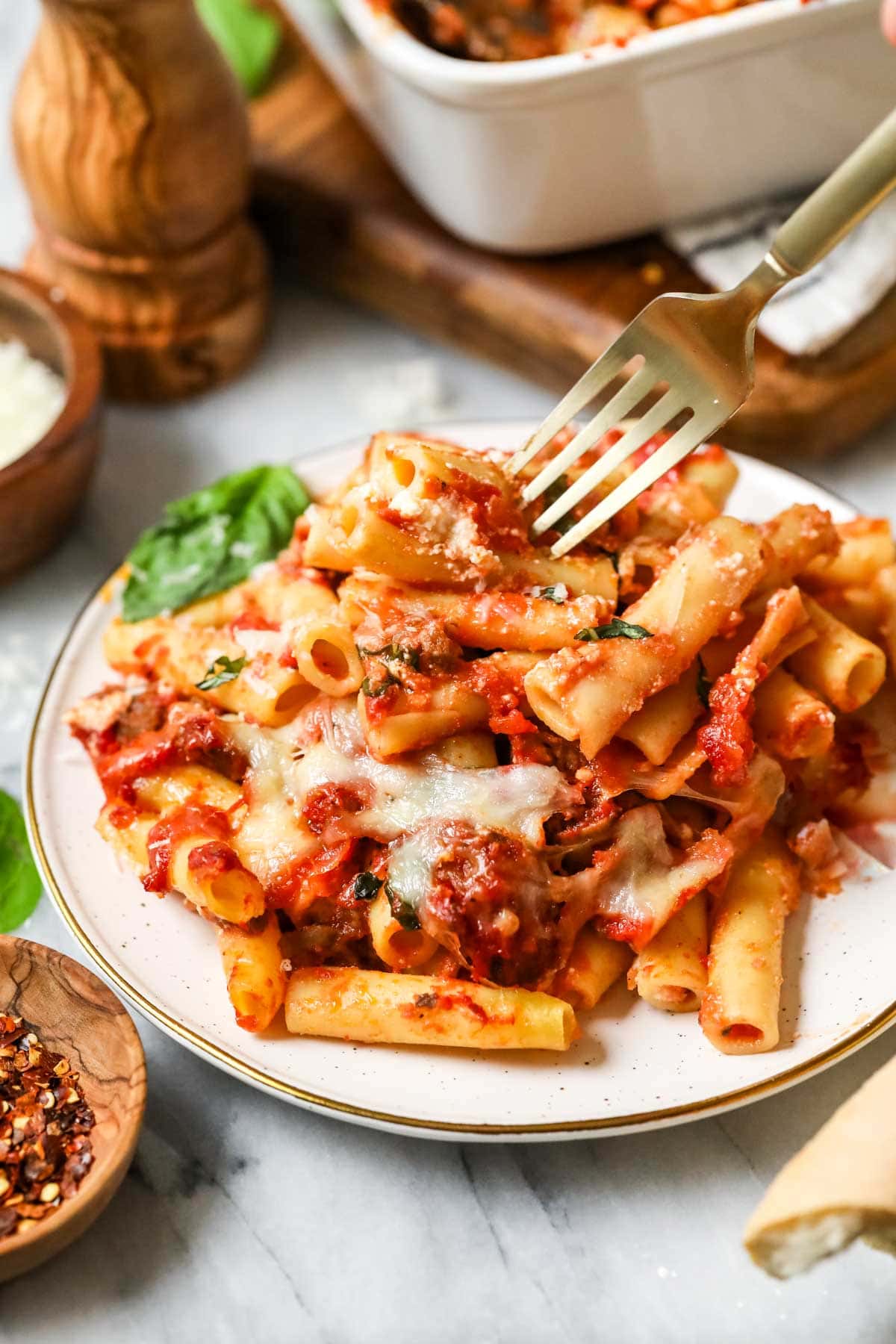 Plate with a serving of baked ziti.