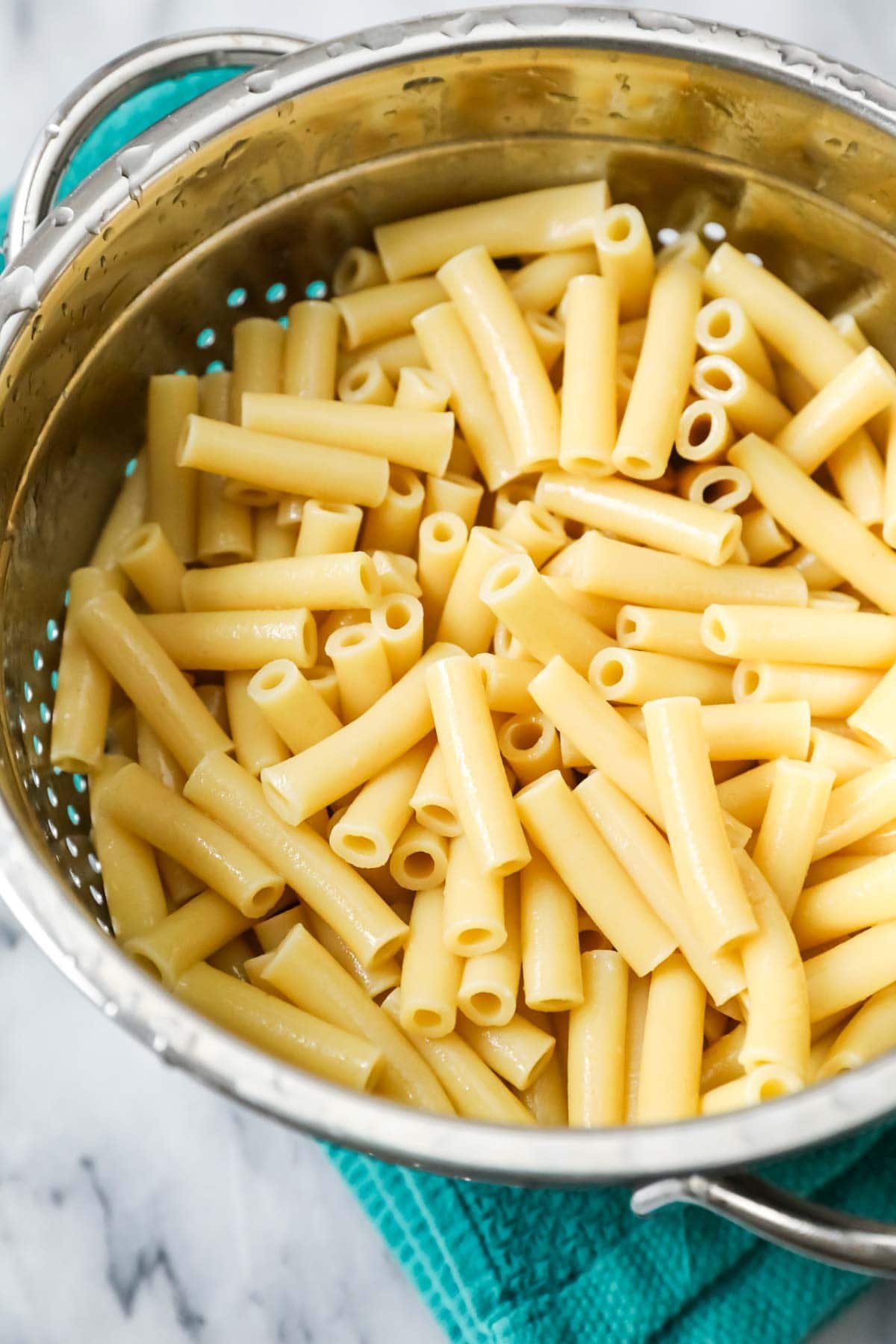 Colander of ziti noodles after cooking.