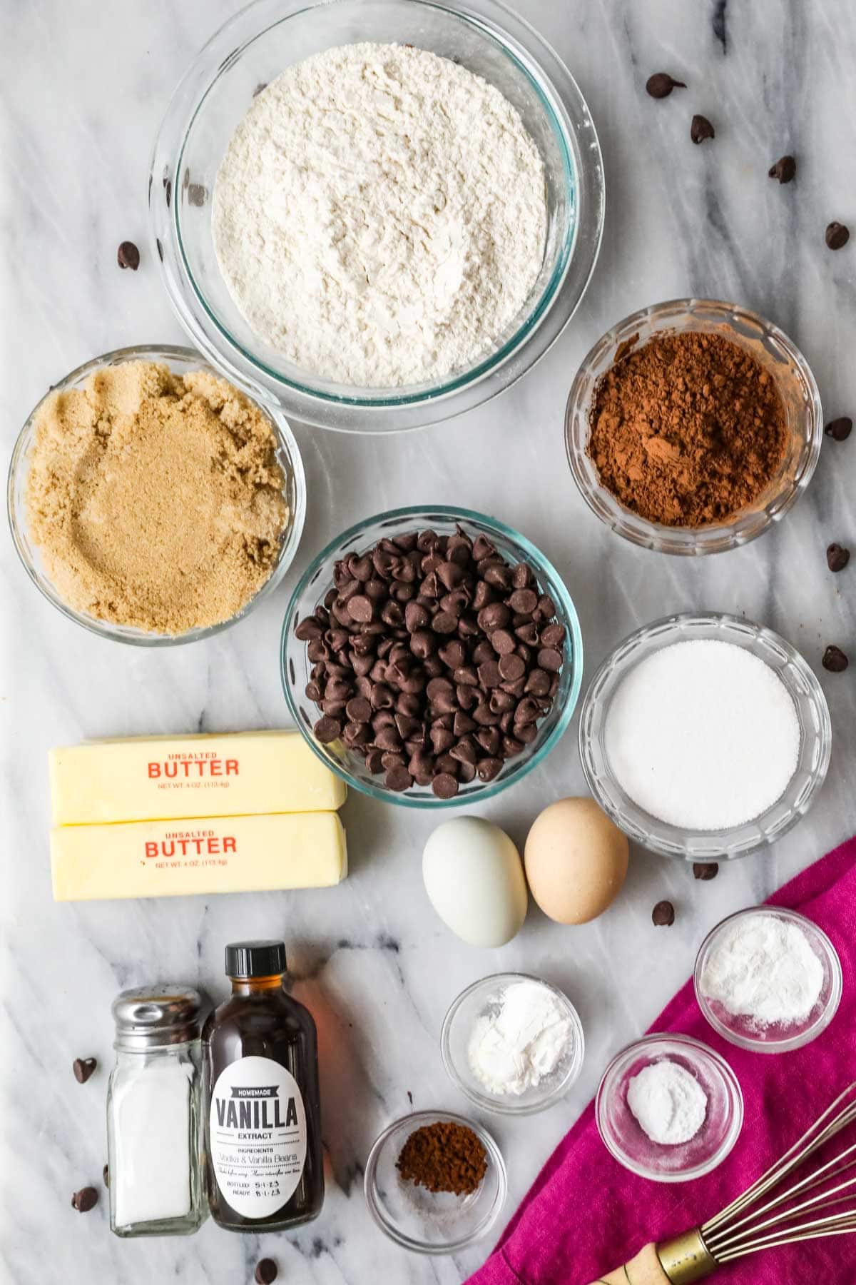 Overhead view of ingredients including cocoa powder, chocolate chips, brown sugar, and more.