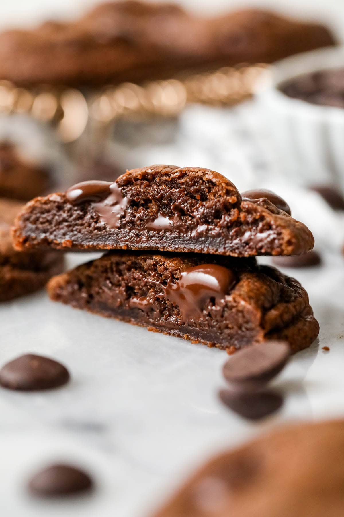 Two halves of a double chocolate chip cookie stacked on top of each other.