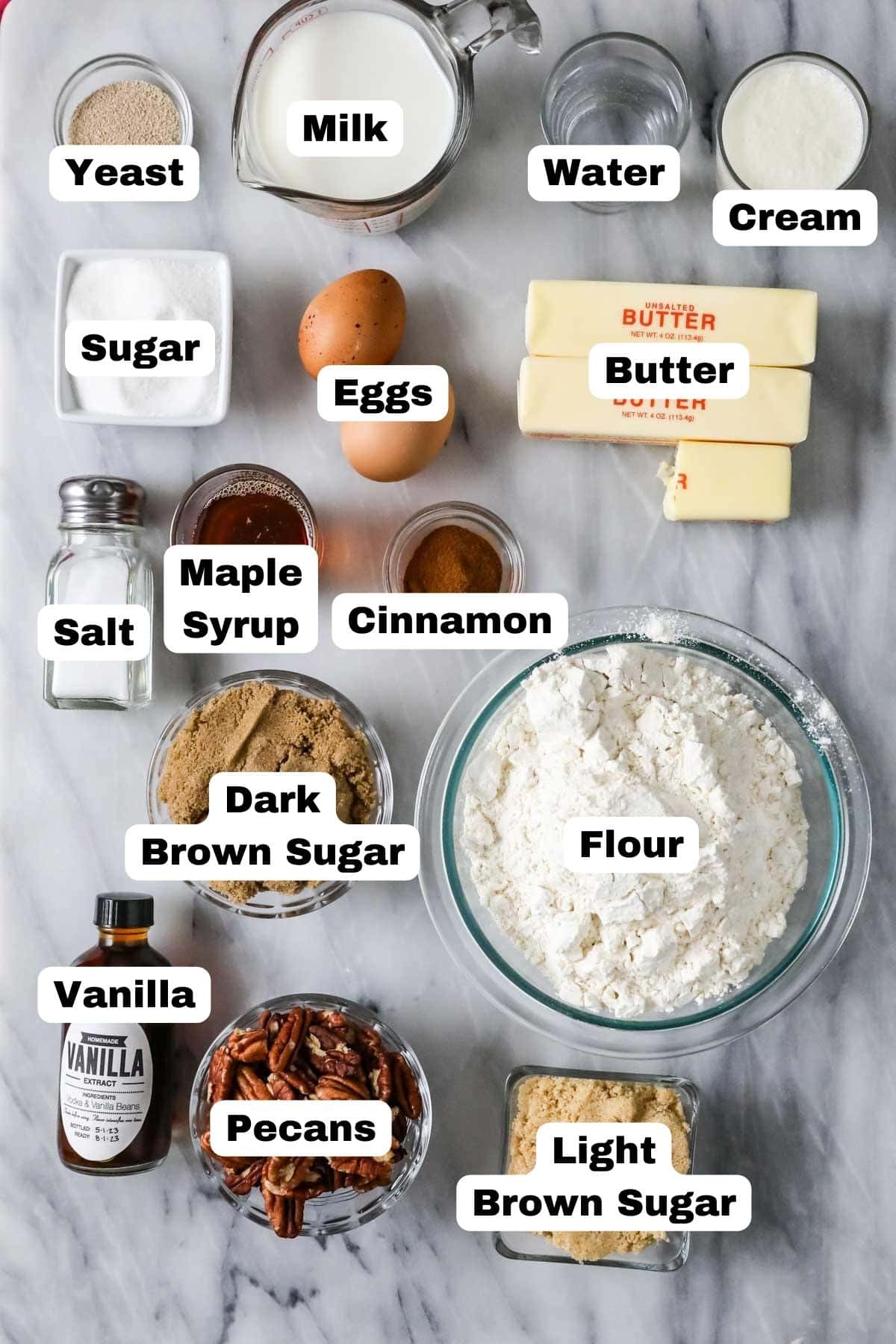 Overhead view of labeled ingredients including brown sugar, pecans, yeast, and more.