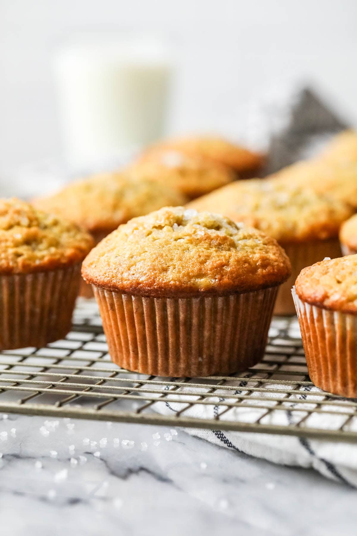 Rows of sourdough banana muffins on a cooling rack.