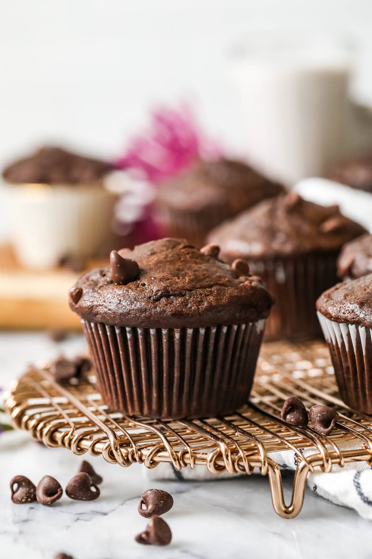 Chocolate banana muffins on a cooling rack.