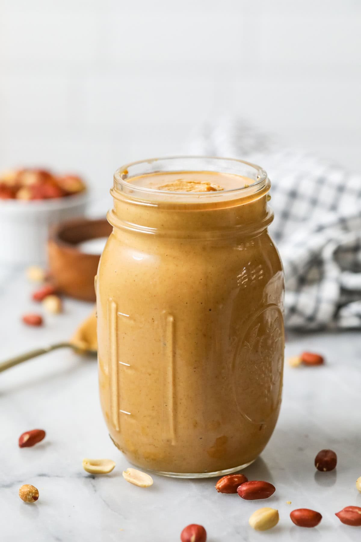 Head-on view of a jar of homemade peanut butter.