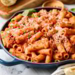 Skillet of homemade rigatoni topped with freshly grated parmesan cheese.