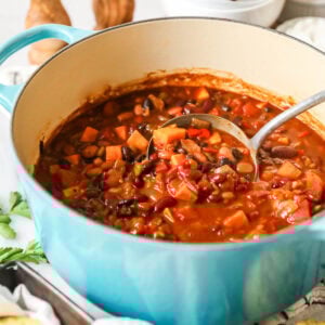 Pot of vegetarian chili made with sweet potato, beans, and more.