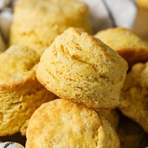 Tall cornbread biscuits with flaky layers in a pile.