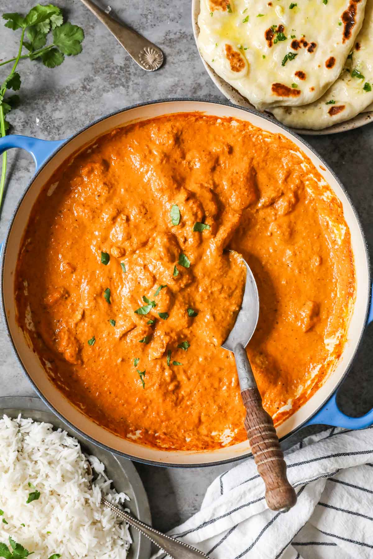 Overhead view of butter chicken in a large dutch oven.