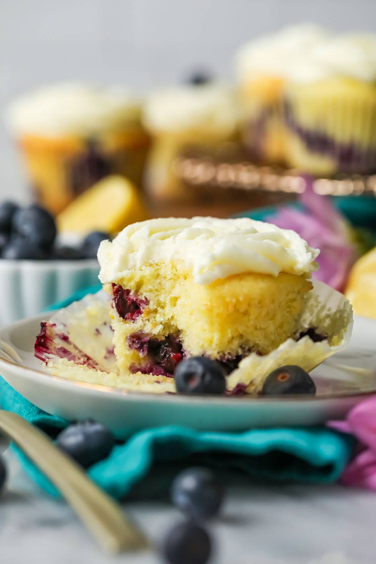 Bite missing from a lemon blueberry cupcake.