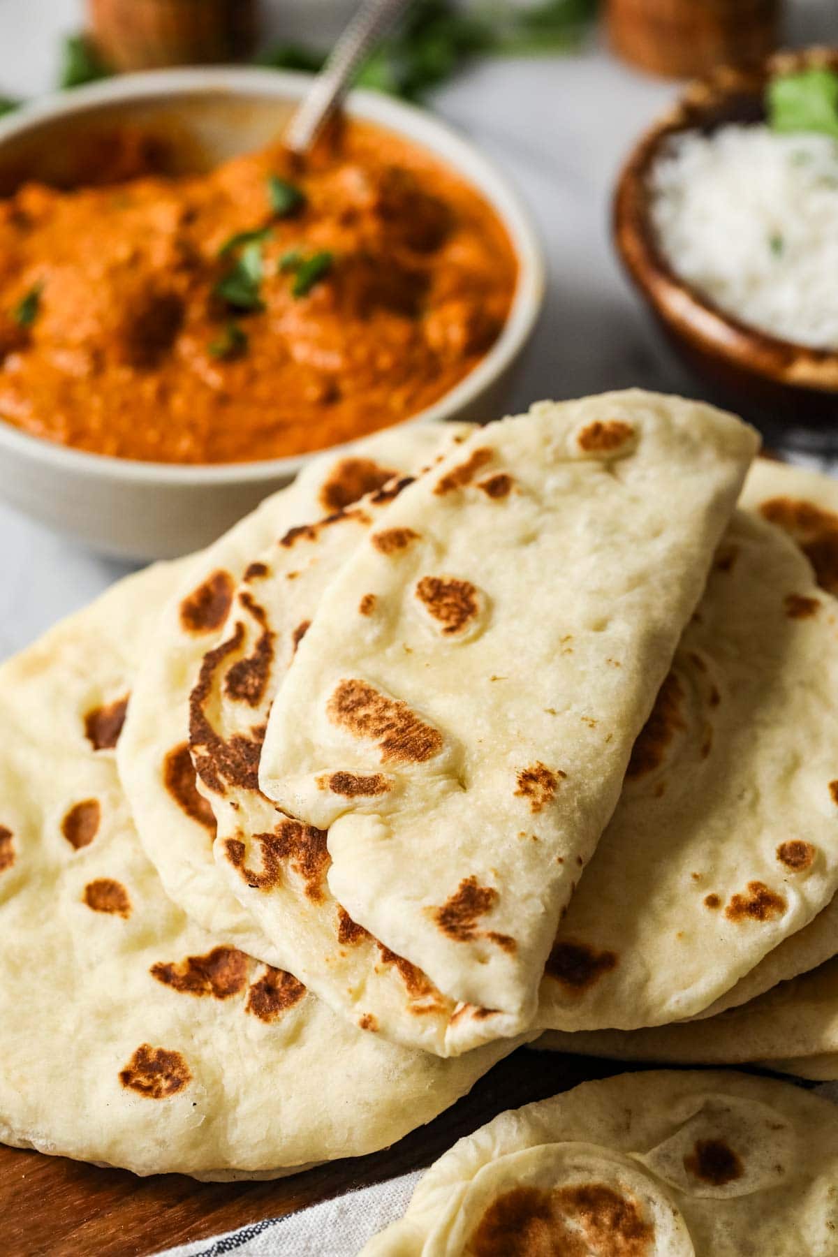 Naan that's been folded over to show its pliability.