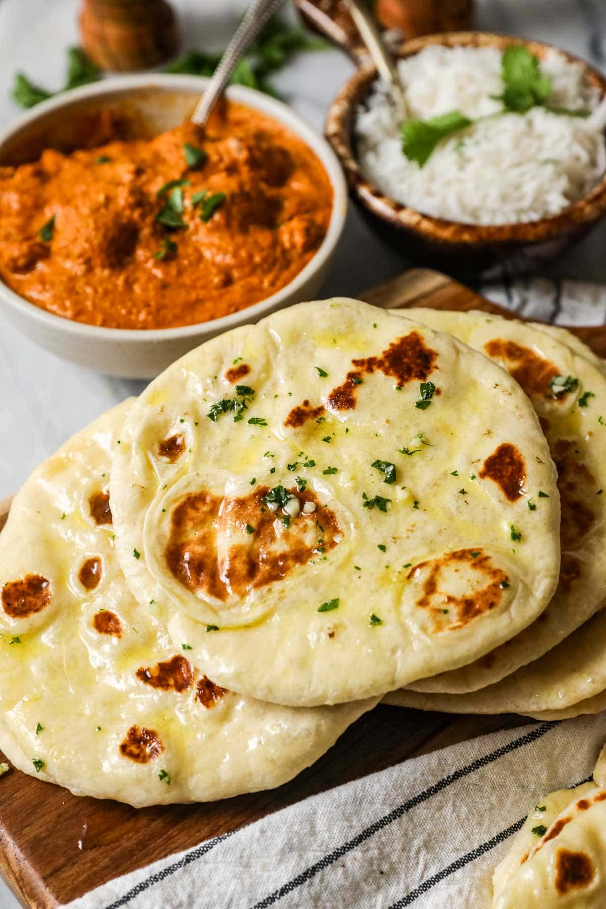 Pile of homemade naan including garlic naan.