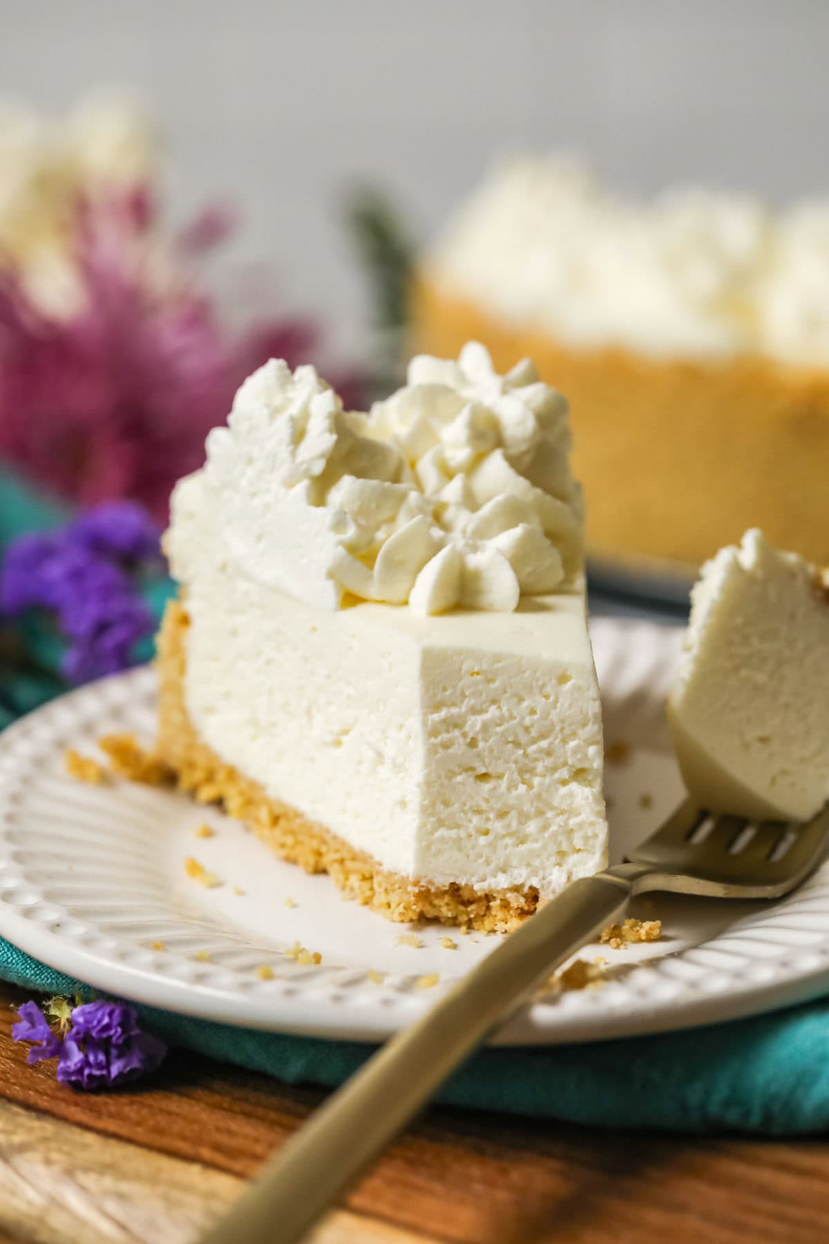 Bite missing from a slice of no-bake cheesecake.