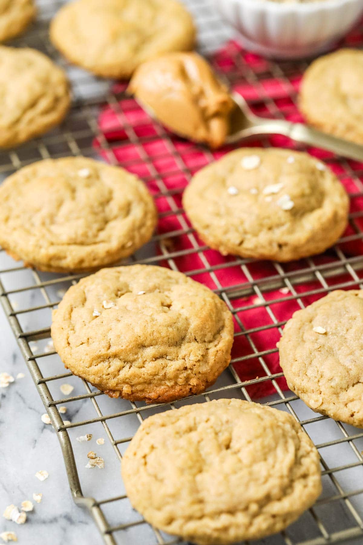 Peanut butter oatmeal cookies cooling on a gold cooling rack