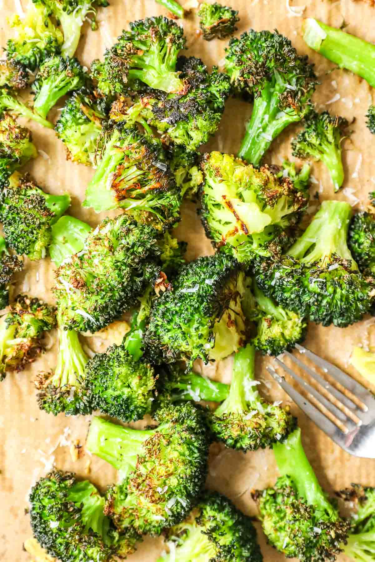 Overhead view of roasted broccoli on a baking sheet.