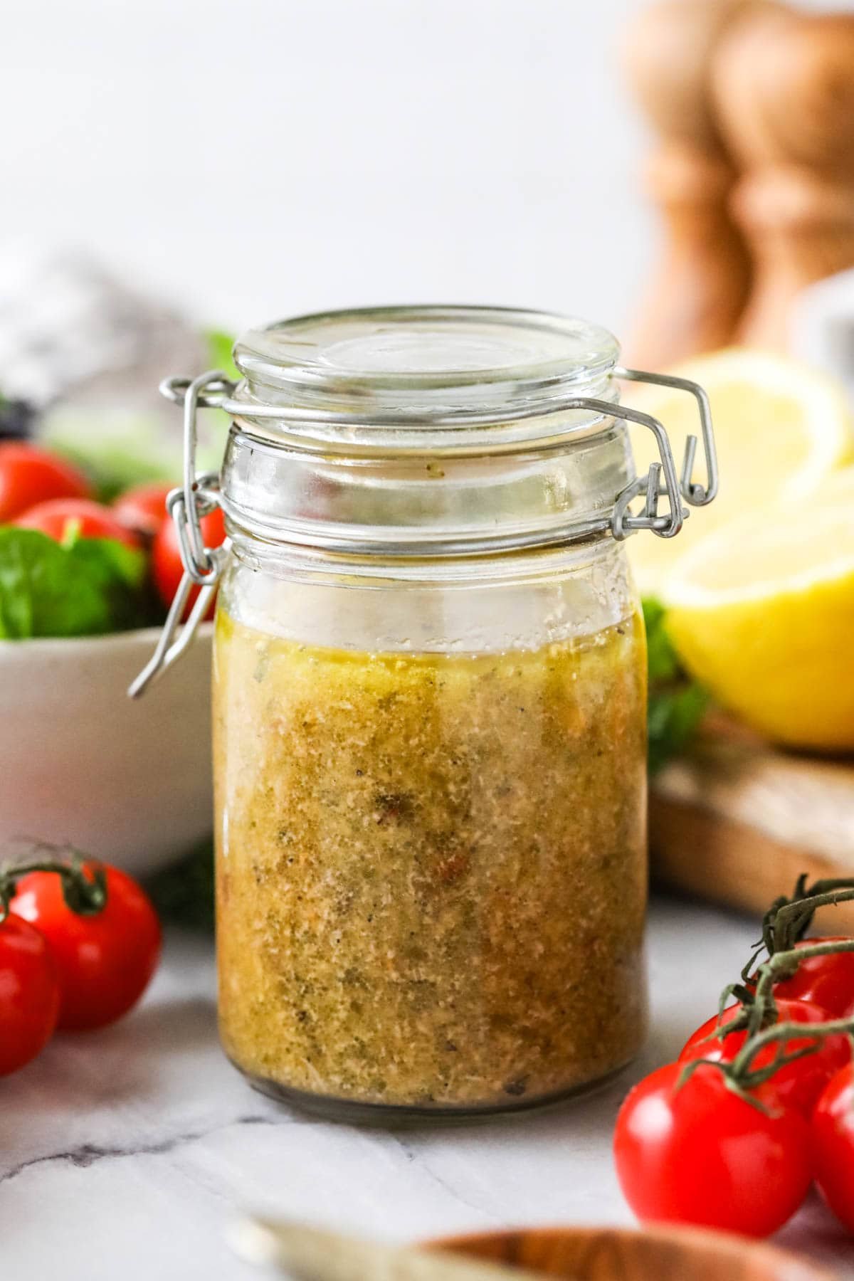 Jar of homemade dressing made with oregano, basil, parmesan, and more.