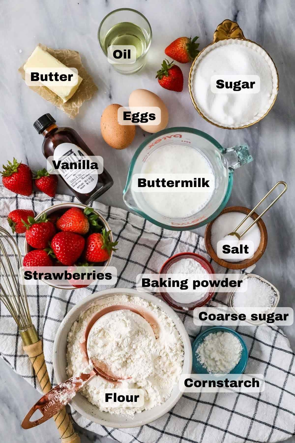 Overhead view of labeled ingredients including strawberries, flour, buttermilk, and more.