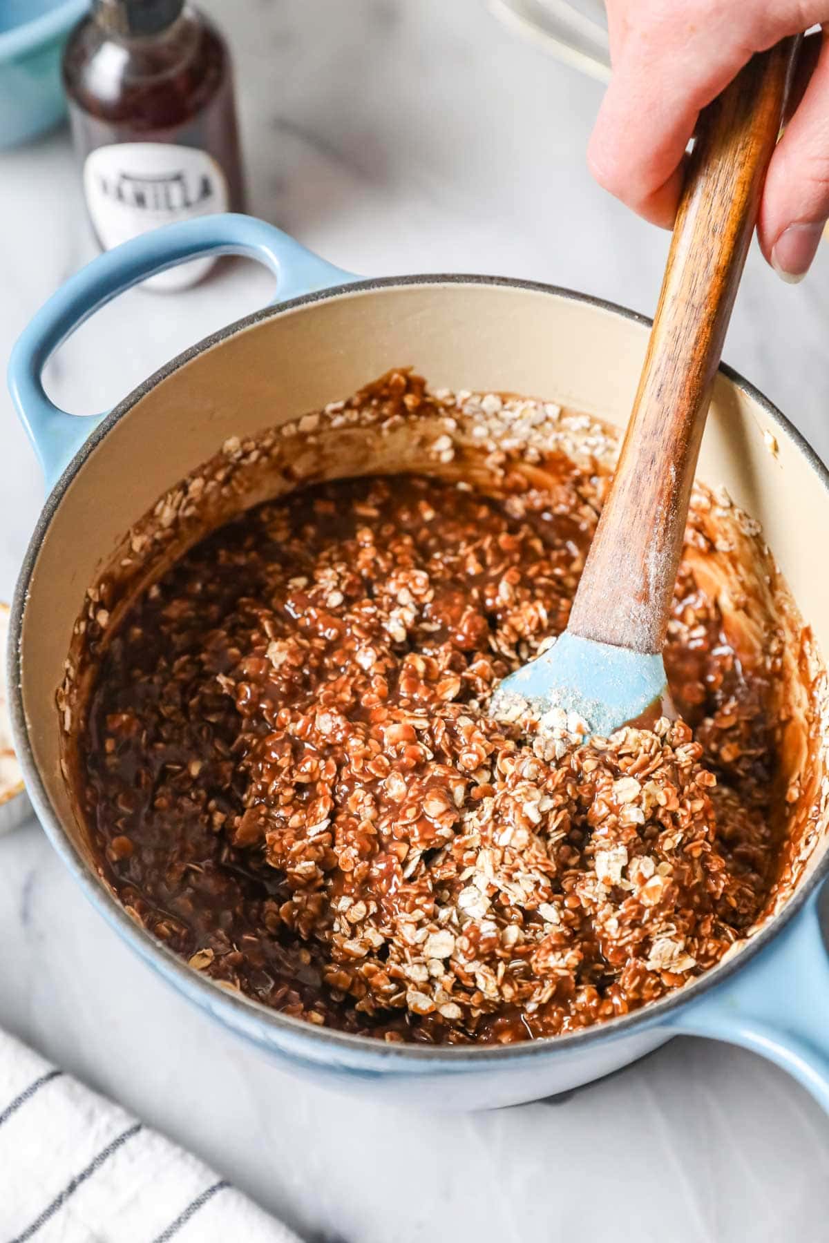 Stirring oats into chocolate mixture. 