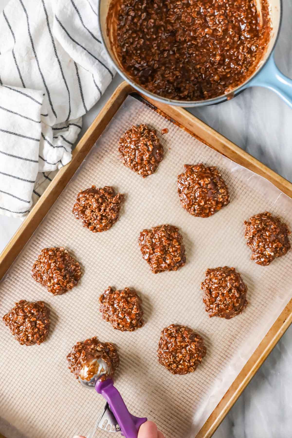 Dropping cookie batter onto baking sheet. 