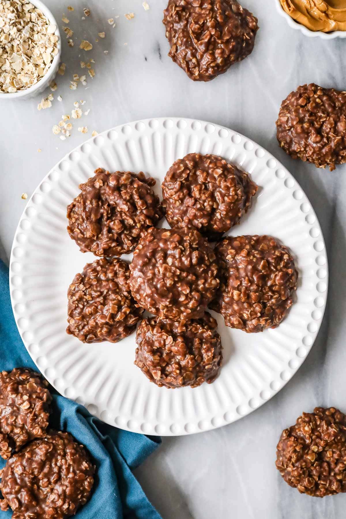 Overhead of chocolate peanut butter no-bake cookies on a white plate.