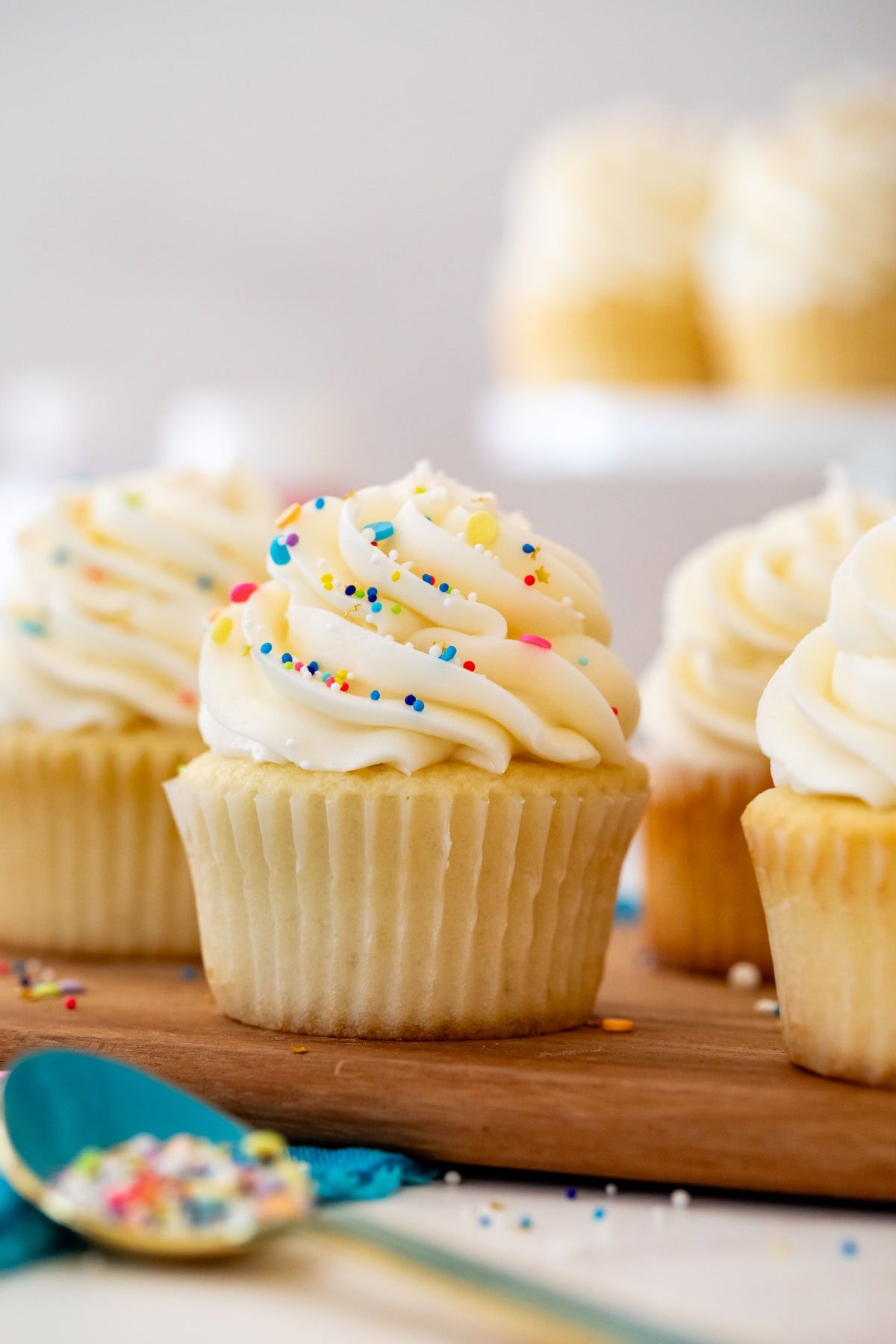 Head-on view of a cupcake frosted with buttercream frosting and sprinkles.