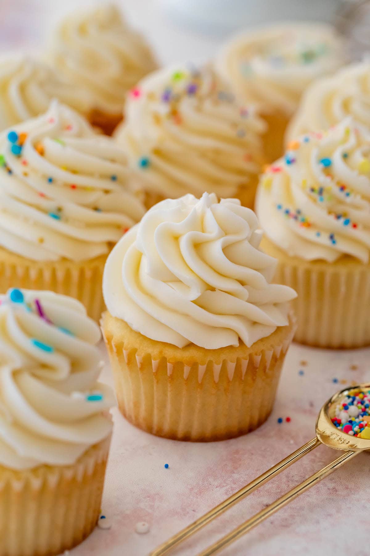 Cupcakes topped with large swirls of buttercream frosting.