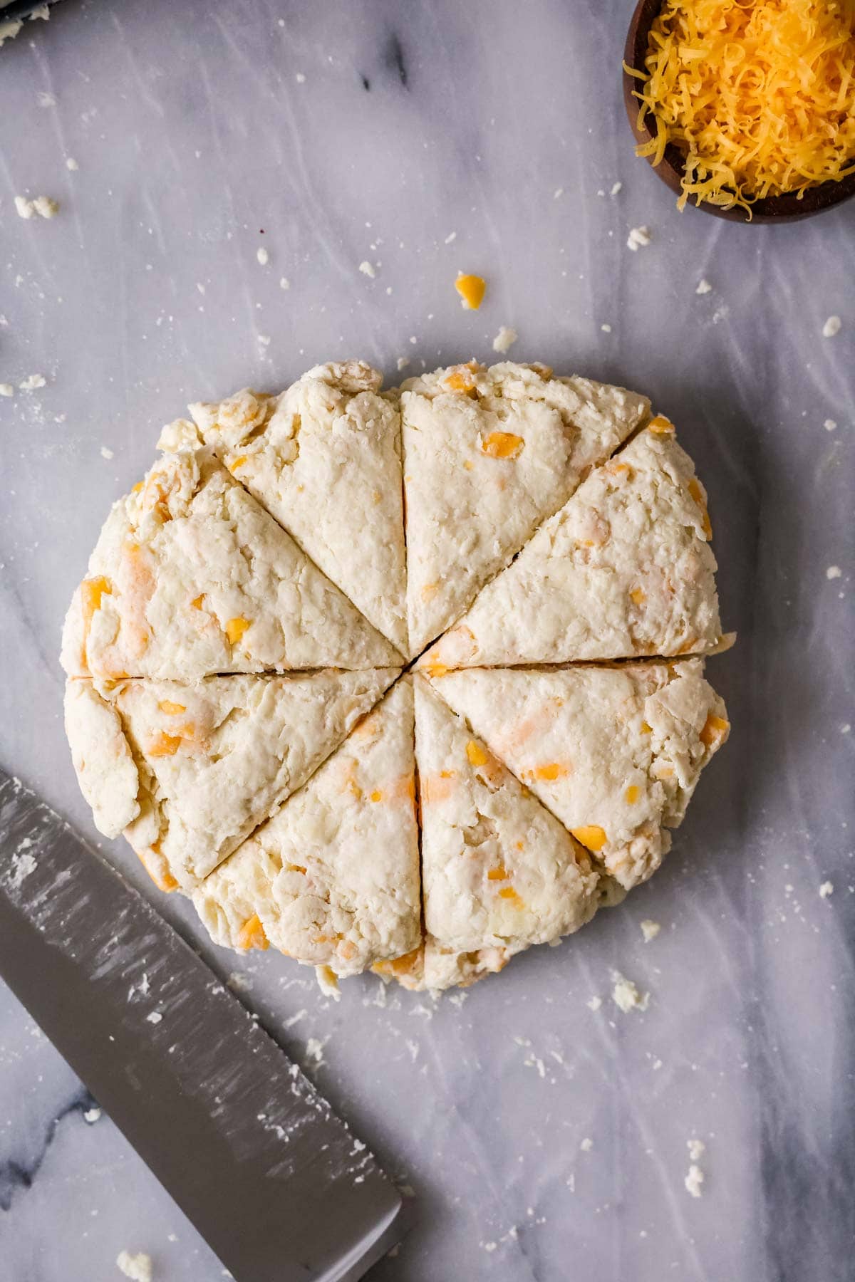 Overhead view of a round scone dough that's been cut into eight wedges.