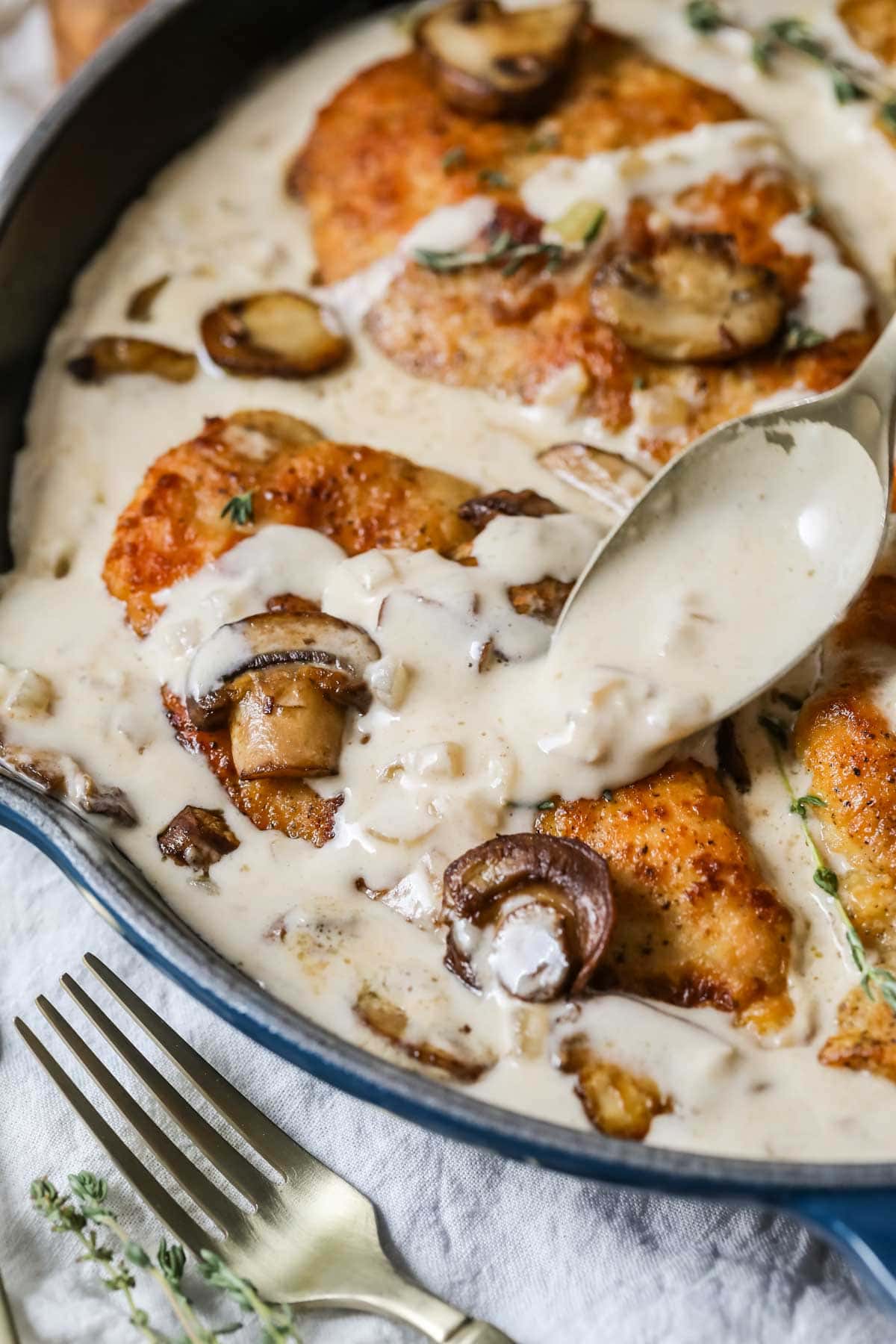Close-up view of creamy mushroom chicken in a skillet.