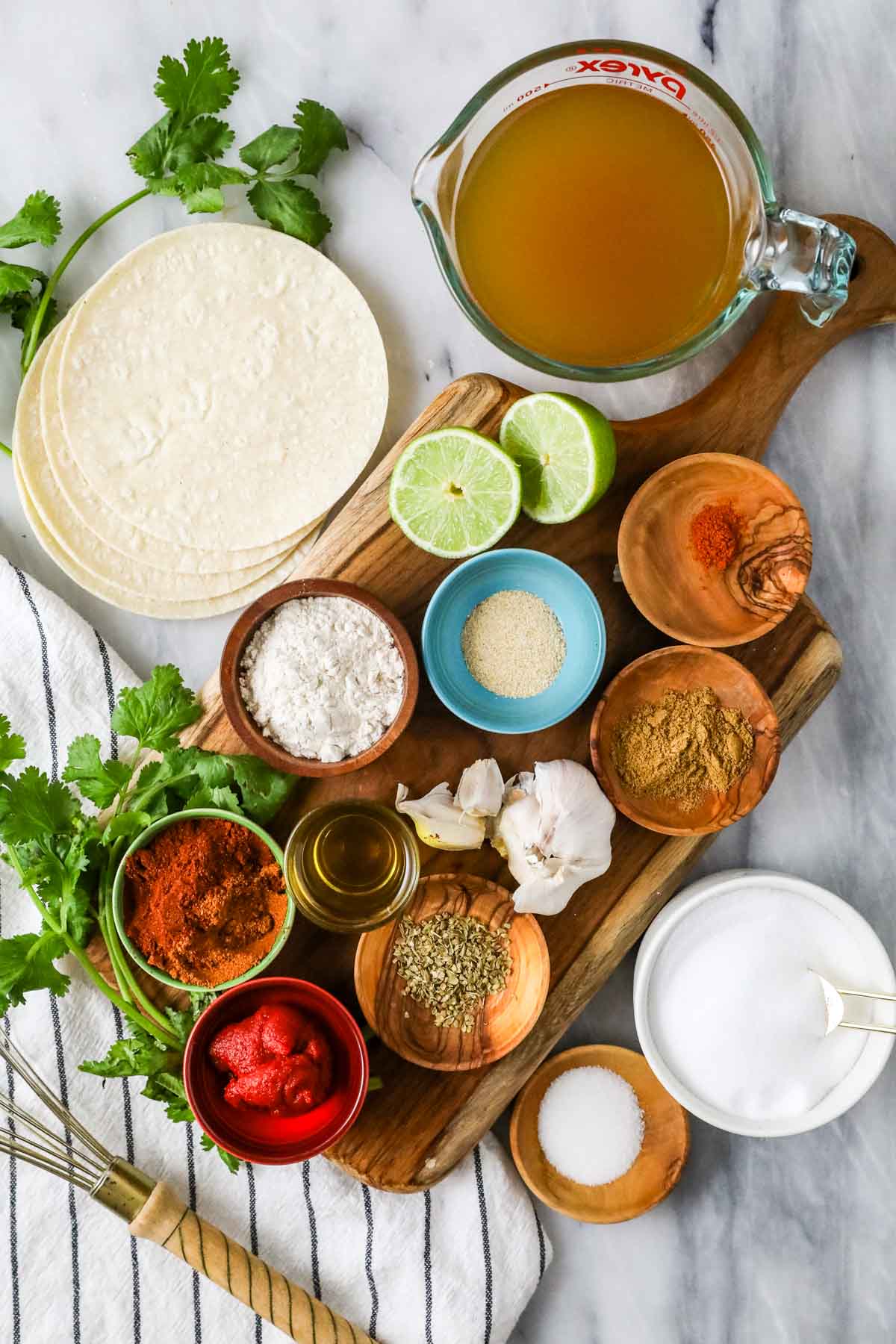 Overhead view of ingredients including flour, spices, sugar, chicken broth, and more.
