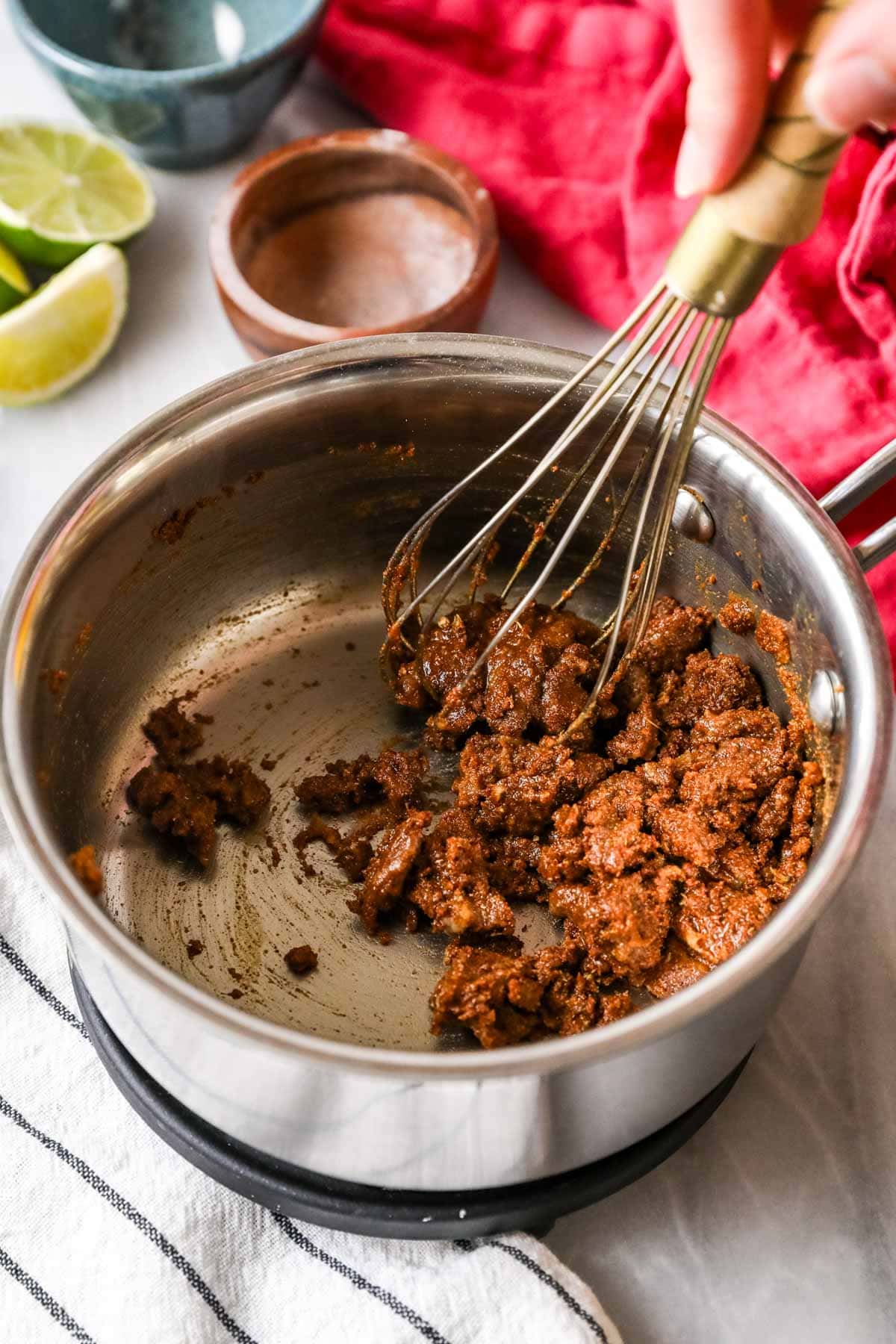 Cooking flour and spices in oil to make enchilada sauce.