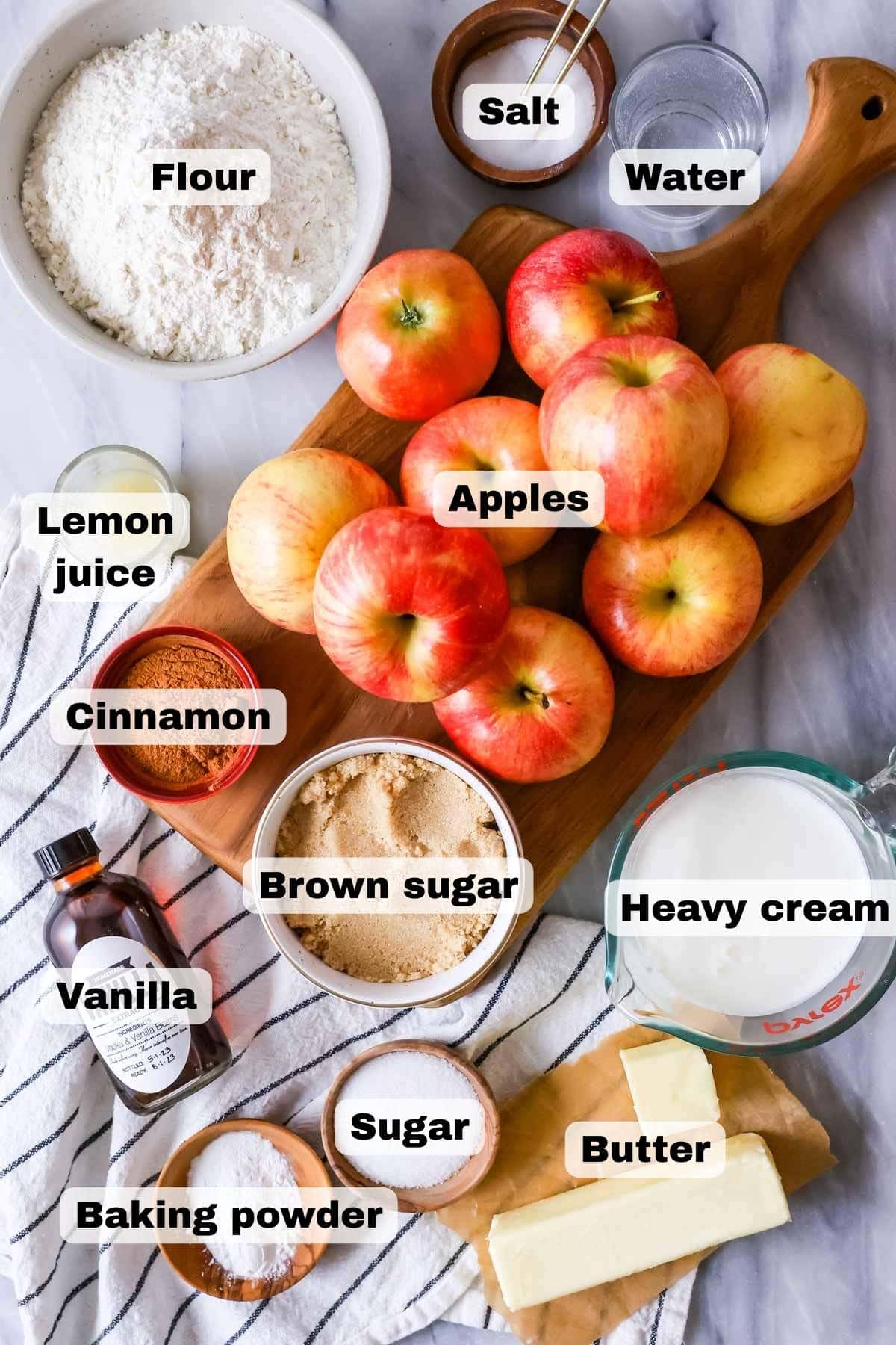 Overhead view of ingredients including apples, brown sugar, flour, and more.